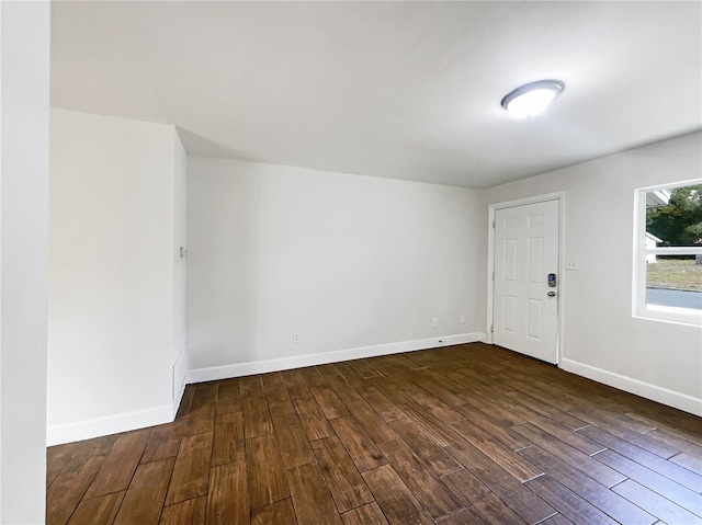 empty room with dark wood-type flooring