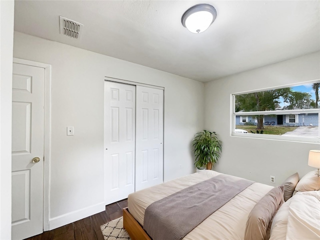 bedroom featuring a closet and dark wood-type flooring