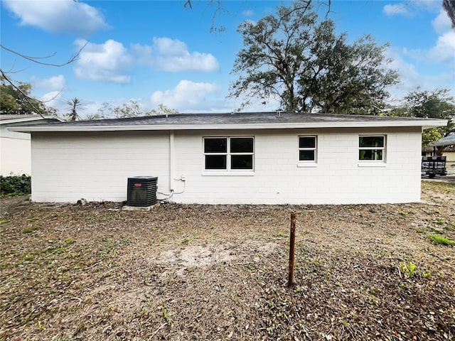 rear view of house featuring central AC