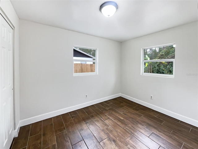 unfurnished bedroom featuring multiple windows and a closet