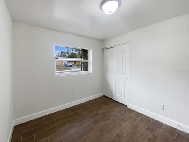 spare room with dark hardwood / wood-style floors