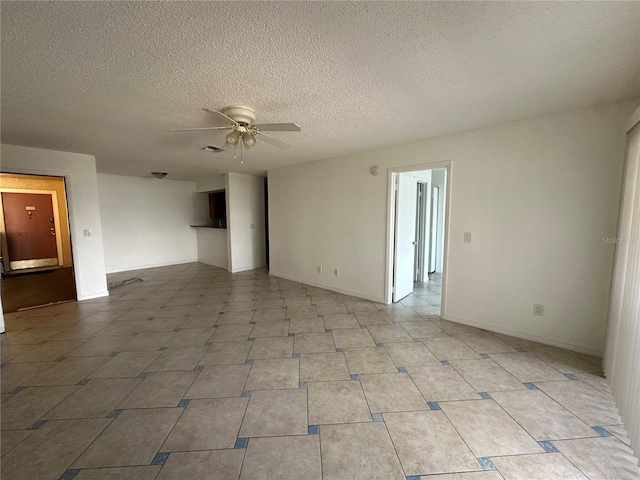 empty room featuring ceiling fan and a textured ceiling