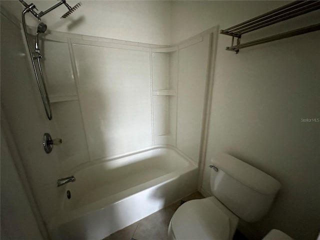 bathroom with tile patterned flooring, toilet, and washtub / shower combination