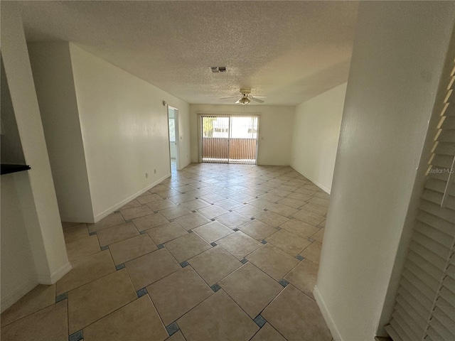 empty room with a textured ceiling and ceiling fan