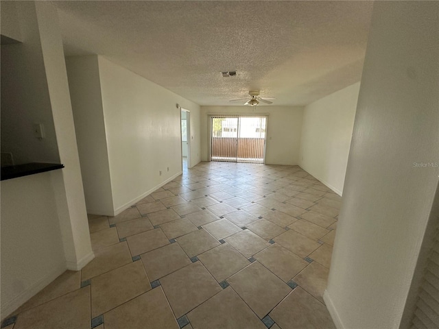 unfurnished room featuring ceiling fan and a textured ceiling