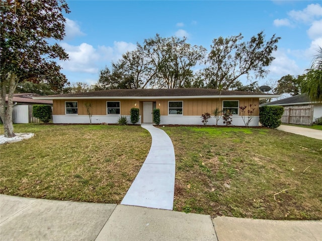 single story home with a front lawn