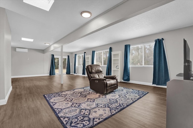 living area with dark wood-type flooring and a wall mounted air conditioner