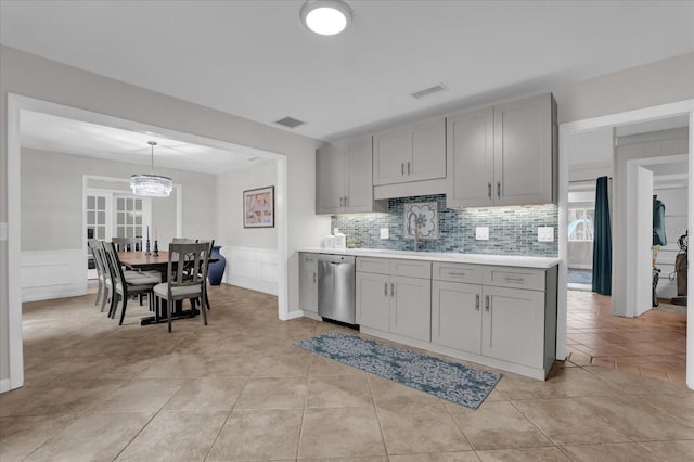 kitchen featuring light tile patterned flooring, gray cabinets, dishwasher, and sink