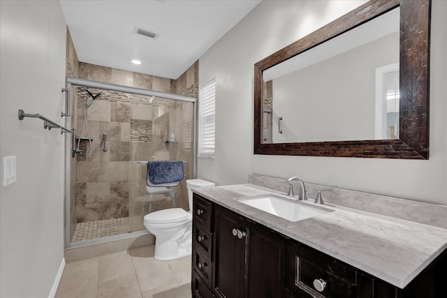 bathroom with toilet, tile patterned flooring, a shower with door, and vanity