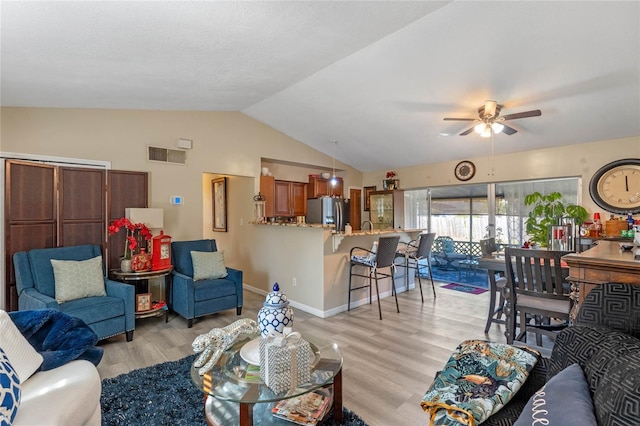 living room with light wood-type flooring, ceiling fan, and lofted ceiling