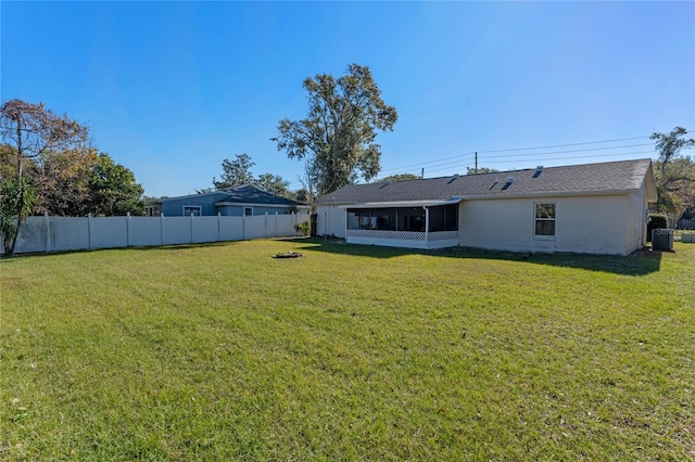 view of yard featuring central AC and a sunroom