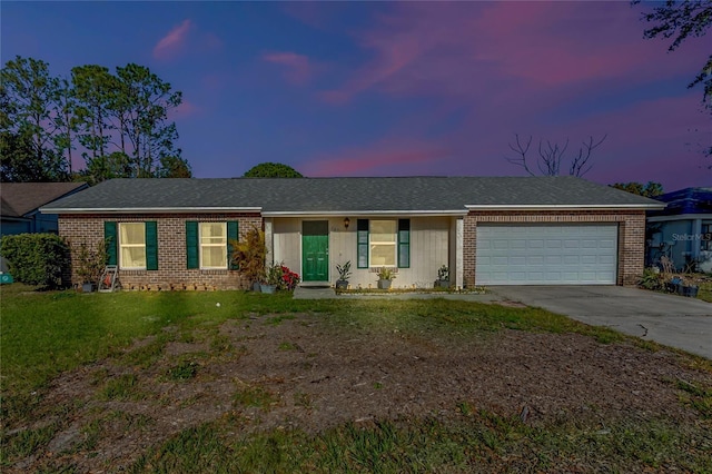 single story home with a lawn and a garage