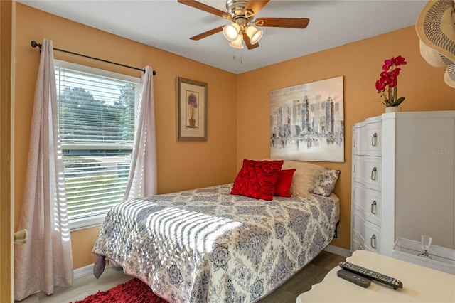 bedroom featuring dark hardwood / wood-style flooring and ceiling fan