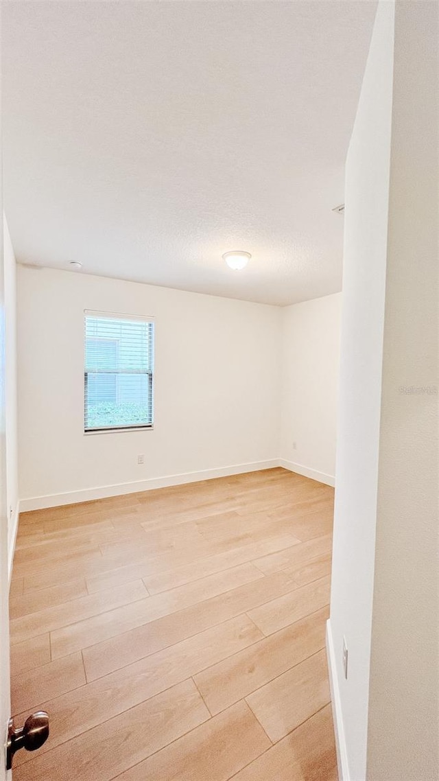 spare room with light wood-type flooring