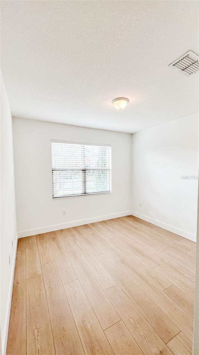 unfurnished room featuring light hardwood / wood-style flooring