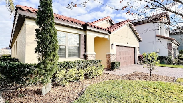 mediterranean / spanish-style house with a garage