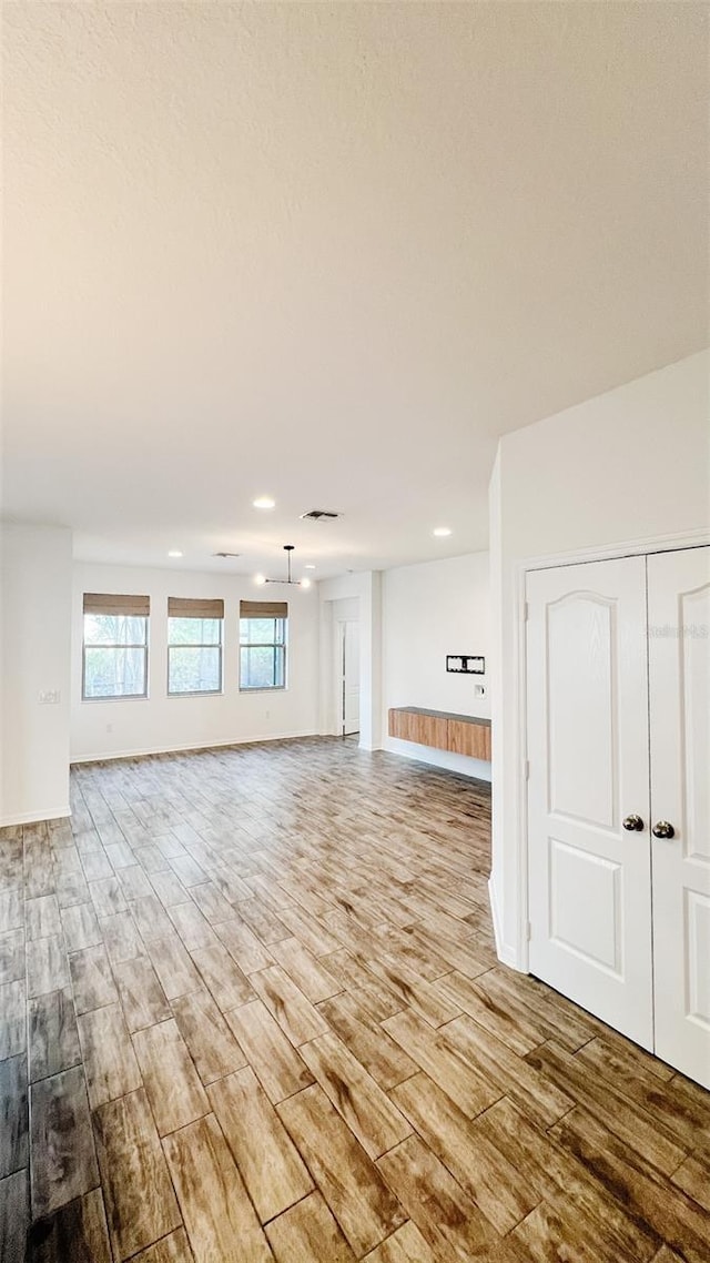 unfurnished living room with light hardwood / wood-style flooring