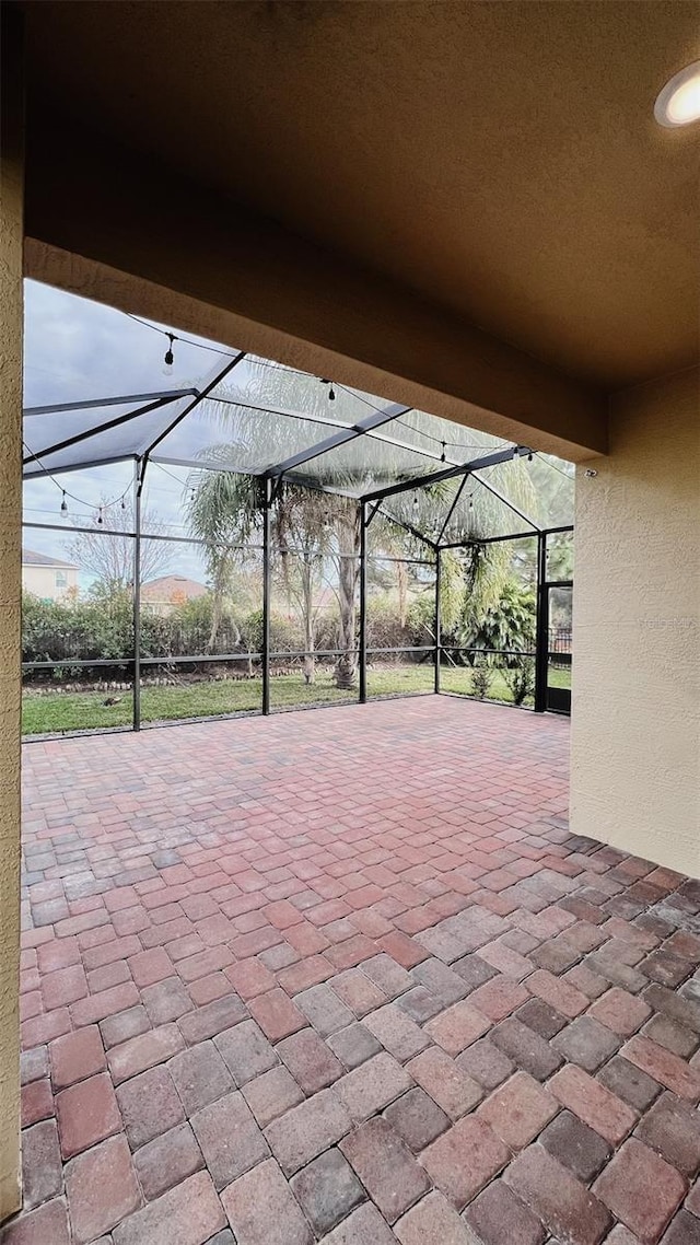 view of patio with a lanai