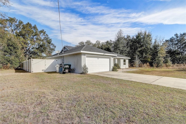 view of property exterior with a garage and a lawn