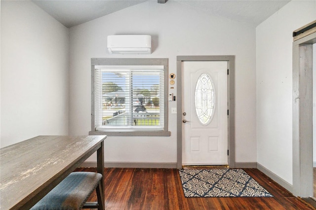 foyer with dark hardwood / wood-style flooring, vaulted ceiling, and a wall mounted AC