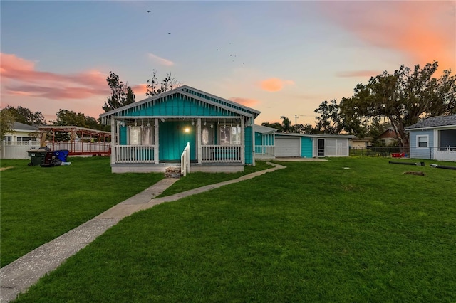 211 Indiana Ave, Saint Cloud, FL 34769 - view of front of house featuring fence, a porch, board and batten siding, and a yard