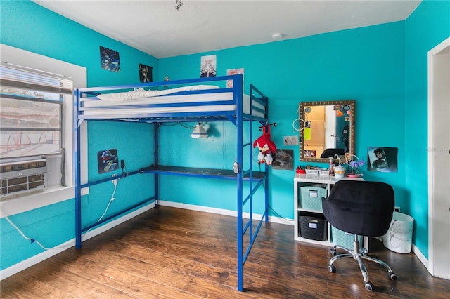 bedroom featuring baseboards and wood finished floors