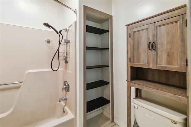 bathroom featuring toilet and washtub / shower combination