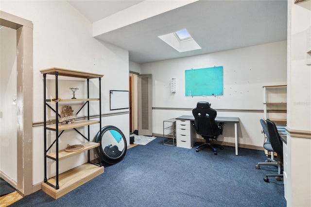 carpeted office space with a skylight and baseboards