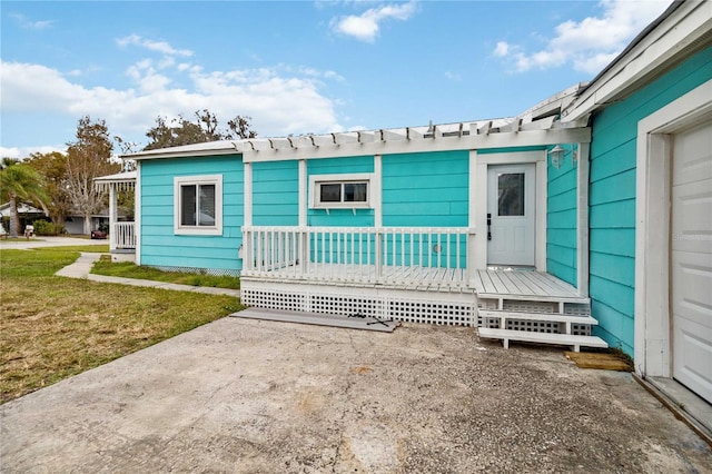 exterior space featuring covered porch and a yard