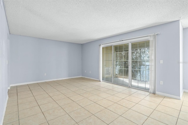 tiled empty room with a textured ceiling