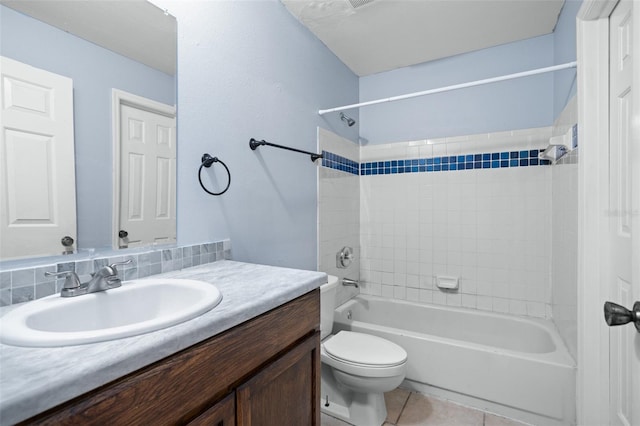 full bathroom featuring tile patterned floors, vanity, toilet, and tiled shower / bath