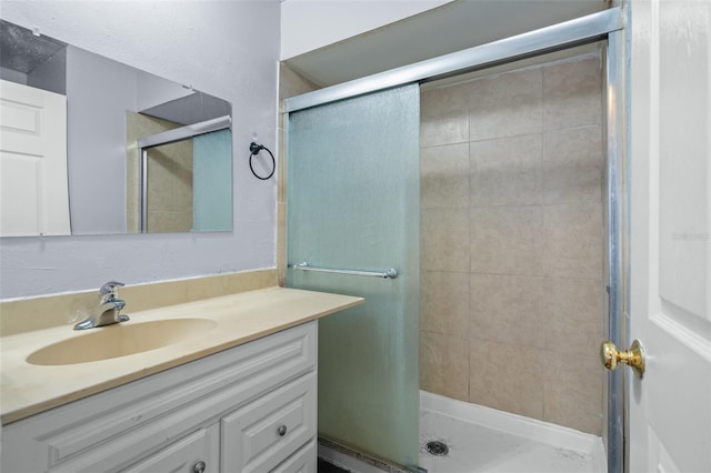 bathroom with vanity and a shower with door