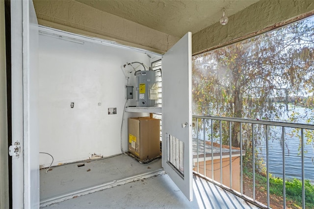 balcony with water heater and a water view