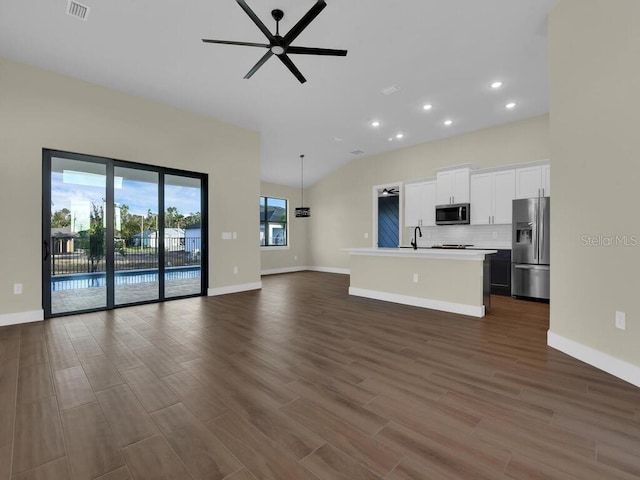 unfurnished living room featuring sink, vaulted ceiling, dark hardwood / wood-style flooring, and ceiling fan