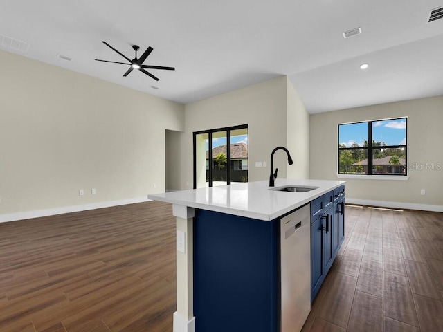 kitchen featuring dark hardwood / wood-style floors, an island with sink, sink, and stainless steel dishwasher