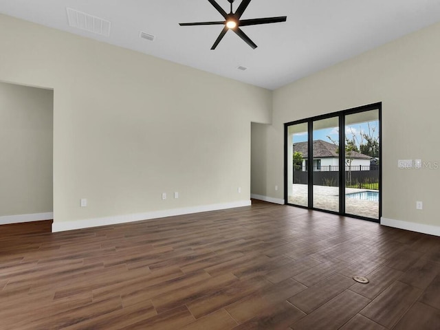 unfurnished room with dark wood-type flooring and ceiling fan