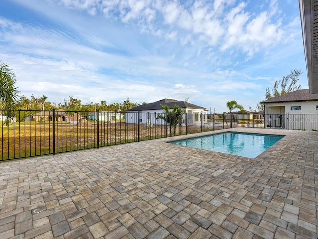 view of swimming pool with a patio and a yard