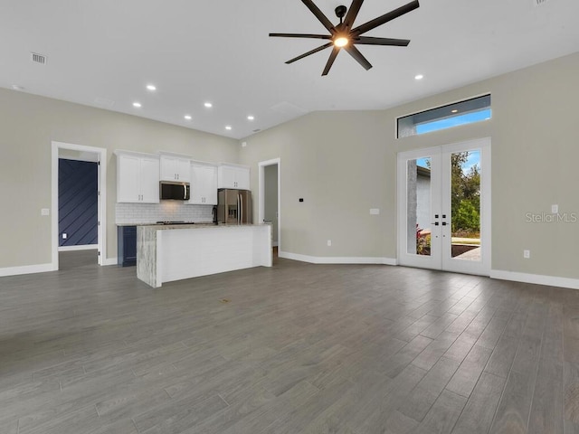 unfurnished living room with visible vents, a ceiling fan, dark wood-style floors, french doors, and baseboards