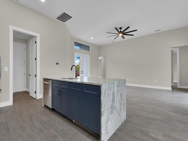 kitchen featuring visible vents, light wood-style flooring, open floor plan, and a sink