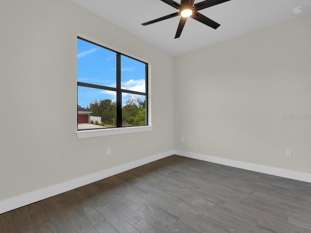 unfurnished room featuring baseboards, wood finished floors, and a ceiling fan