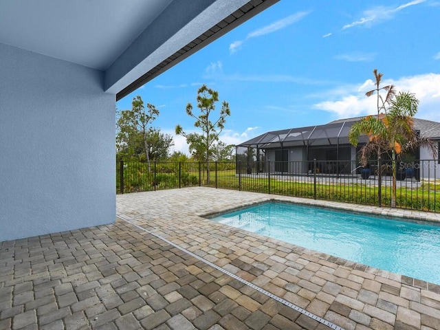 view of swimming pool featuring a patio area, a fenced in pool, and fence