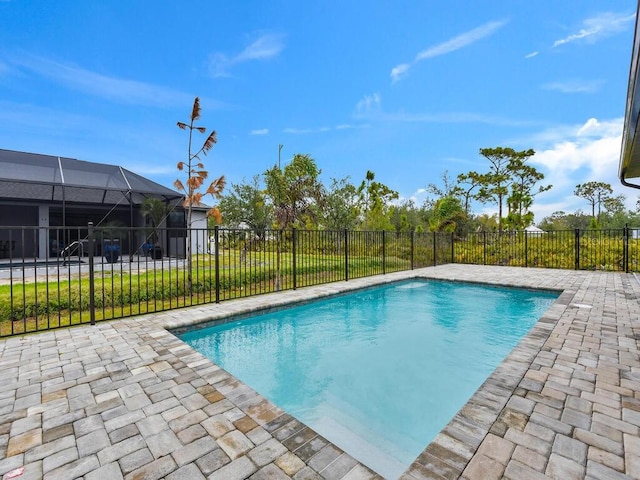 view of pool featuring a lanai, a fenced in pool, a patio, and a fenced backyard