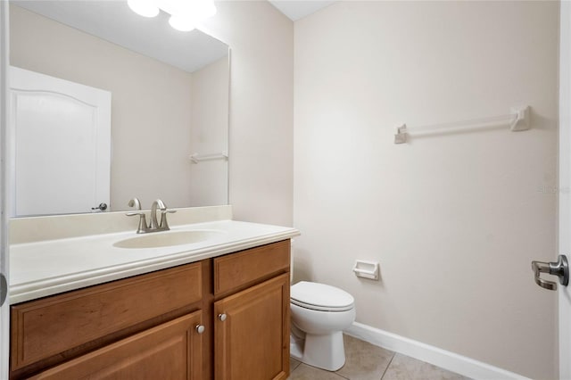 bathroom featuring vanity, tile patterned floors, and toilet