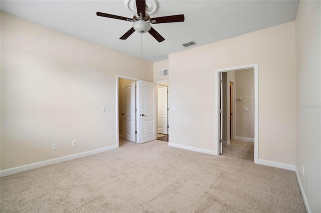 unfurnished bedroom featuring ceiling fan and light carpet