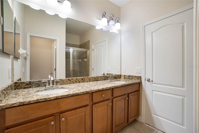 bathroom with vanity, tile patterned flooring, and a shower with door