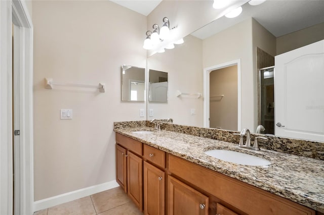 bathroom with vanity, a shower with door, and tile patterned flooring