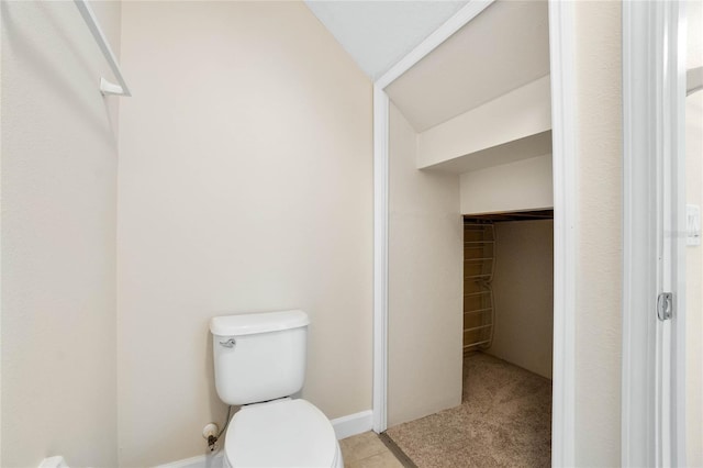 bathroom featuring lofted ceiling and toilet