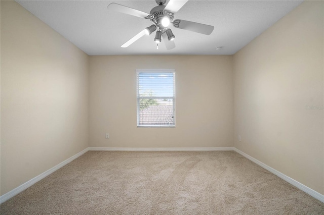 spare room featuring ceiling fan and light carpet