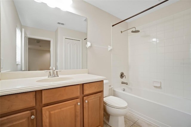 full bathroom with vanity, tile patterned flooring, tiled shower / bath combo, and toilet