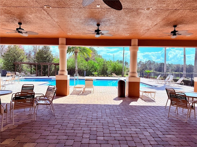 view of pool featuring a patio and ceiling fan